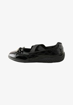 Chaussure plate en cuir verni noir avec brides croisées élastiques, nœud décoratif et semelle texturée pour une meilleure adhérence.