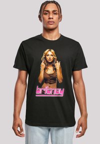 Zwarte katoenen t-shirt met een kleurrijke grafische afdruk van een vrouw met lang haar, accentueert met de naam "britney" in roze, vetgedrukte letters.