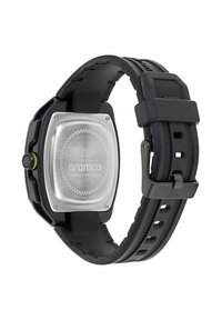 Melnas gumijas pulksteņi ar kvadrātveida nerūsējošā tērauda korpusu, caurspīdīgu aizmuguri un zaļajiem akcentiem. Aprīkots ar teksturētu siksniņu un regulējamu sprādzi.