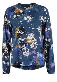 Blommig långärmad topp med en marinblå bakgrund och vita, lila och gula blommor. Rund halsringning, mjukt tyg och rundad nederkant.