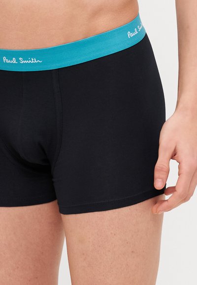 Melni bokseršorti ar tirkīza elastīgu jostu, kurai ir "Paul Smith" logo. Izgatavoti no gludas, elastīgas auduma. Strukturēta piegriezuma.