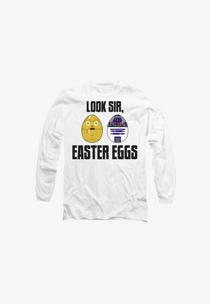 White long-sleeve shirt featuring cartoon egg designs and text "LOOK SIR, EASTER EGGS." One egg is yellow with eyes, the other is blue and white.