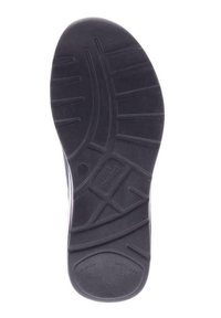 Semelle de chaussure en caoutchouc noir avec des motifs de tread texturés, une section lisse près du talon et du marquage en relief sur la semelle.