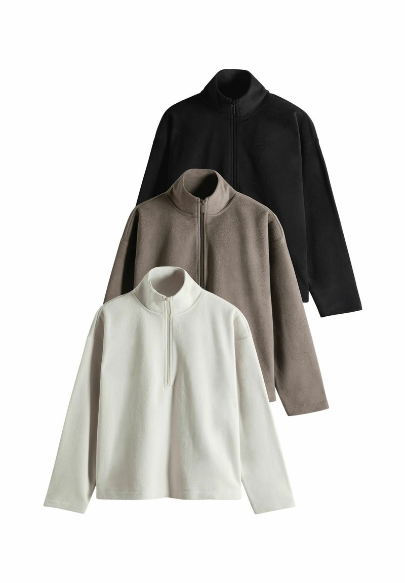 Fleece-Pullover in Schwarz, Taupe und Weiß, mit einem halben Reißverschlusskragen, langen Ärmeln und einer weichen, strukturierten Oberfläche.