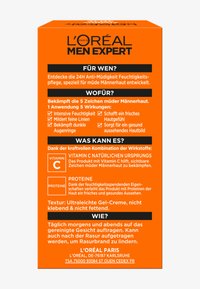 L'Oréal Men Expert anti-fatigue moisturizer box, orange with black text, features skincare benefits and instructions, textured finish, compact design.