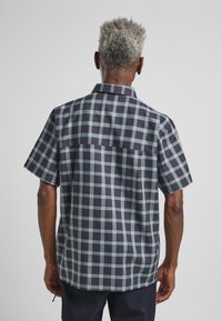 Kurzarmhemd in dunklem Marineblau mit hellblauem Karomuster; verfügt über einen Kragen und eine lockere Passform mit einer geraden Rückenpasse.