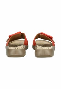 Red closed-back sandals with adjustable straps. Smooth leather upper with a light brown textured sole. Subtle branding on insole.