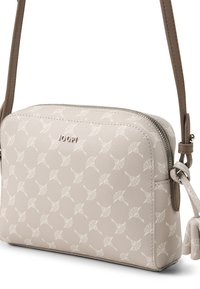 Borsa a tracolla sintetica beige con finitura testurizzata, caratterizzata da un motivo bianco, chiusura con zip e tracolla regolabile con dettaglio a nodo.