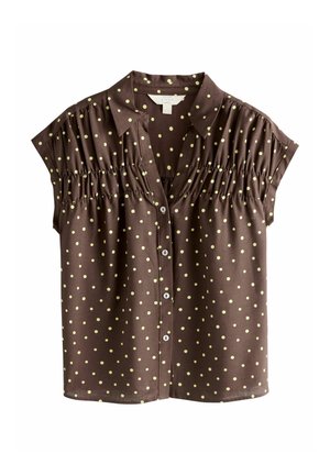 Ruda trumpomis rankovėmis palaidinė su geltonomis taškuotėmis, su sagomis priekyje, su rauktais po pečiais ir smailiu apykakliu.