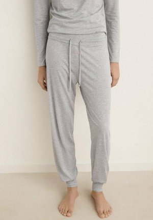 Pantalones jogger de algodón gris con cinturilla elástica, cordón y tobillos ceñidos, que presentan una textura suave y un corte relajado.