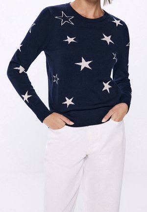 Navy sweater with a round neckline, long sleeves, and cream-colored star patterns. Knit texture with a fitted waist and cuffs.