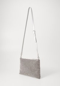 Zwarte en witte houndstooth-gepatroneerde tas, rechthoekige vorm, met een afneembare en verstelbare schouderband en zilveren hardware accenten.