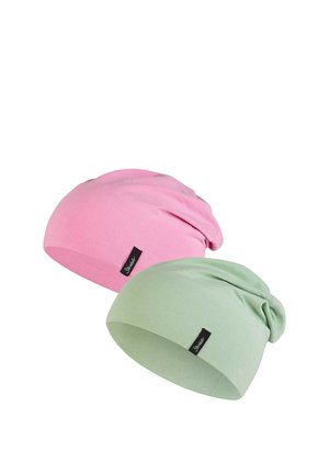 Two soft cotton beanies, one pink and one light green, each with a small black fabric tag on the front side.