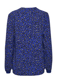 Blouse bleue à manches longues avec motif léopard noir et beige, coupe ample, poignets élastiques, vue de dos sur fond blanc.