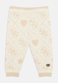 Helle Creme Leggings mit einem Diamantmuster, das Herzen, Sterne und Logos aus goldenen Fäden zeigt; elastischer Bund; gerippte Bündchen.