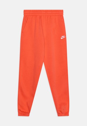 Jasne oranžové tepláky s elastickým pásom, dvoma bočnými vreckami a malým bielym logom Nike na ľavom boku.