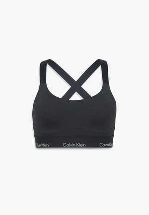 Zwarte Calvin Klein sportbeha met gekruiste schouderbandjes en een gebrandmerkt elastiek aan de onderkant.