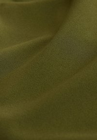 Close-up of smooth, olive green fabric with soft folds and a slightly textured surface.