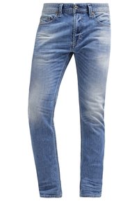 Light blue denim jeans featuring a slim fit, subtle fading, and classic five-pocket design with copper hardware accents.