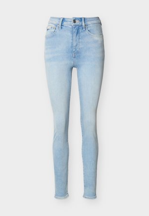 Light blue high-waist skinny jeans with front button and zipper closure, five pockets, and subtle faded detailing.