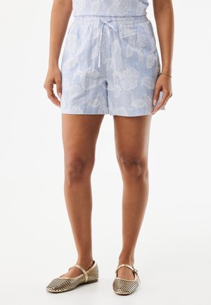 Lichtblauwe shorts met wit bloemenpatroon en strepen, voorzien van een elastische tailleband en trekkoord. Geweven stof met een losse pasvorm.