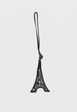 Porte-clés en cuir noir en forme de Tour Eiffel avec des étoiles blanches et le texte "ZADIG", équipé d'une boucle pour l'accrocher.