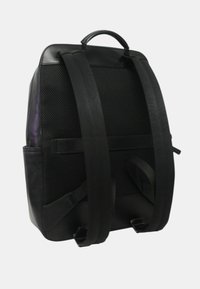 Zaino nero con schienale in rete imbottita, due spallacci regolabili e una maniglia superiore su uno sfondo bianco uniforme.