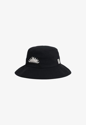 Black bucket hat made of canvas. Features a curved brim and a white sun graphic embroidered on the front. Side tag is visible.