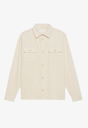 Beige corduroy overhemd met lange mouwen, een puntkraag en twee borstzakken. Heeft een knoopsluiting aan de voorkant en een gestructureerde stof.