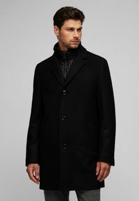 Abrigo de mezcla de lana negro con un cuello estructurado, tres botones y una tapa de cremallera oculta. Cuenta con bolsillos laterales y una textura suave.