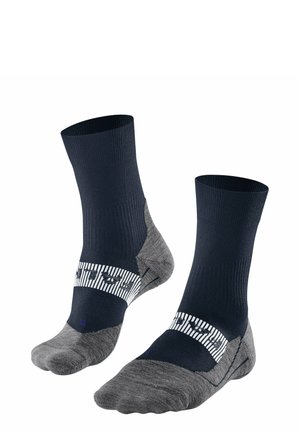 Marineblau und graue Knöchelsocken mit geripptem Muster, gepolstertem Fersenbereich und einem weißen gestreiften Band mit Logo. Weicher Stoff für Komfort und Langlebigkeit.