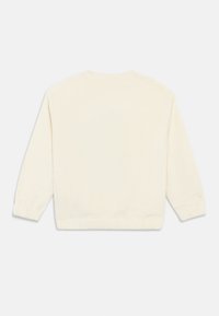 Κρέμα φλις πόλο με στρογγυλή λαιμόκοψη, μακριά μανίκια και ελαστικές μανσέτες, με απαλή, υφασμάτινη επιφάνεια.