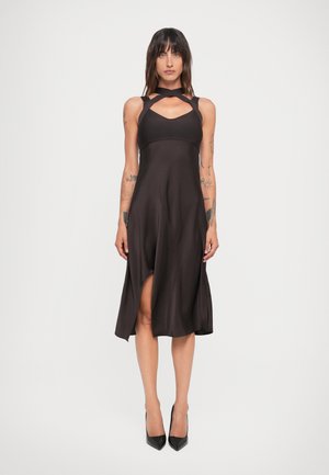 Black sleeveless dress with a fitted bodice and a flared skirt, featuring cut-out detailing at the neckline and a side slit.