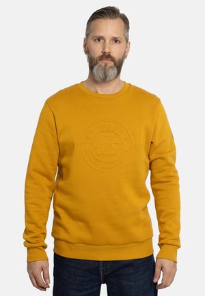 Geel sweatshirt met een ronde halslijn, voorzien van een textuur rondom het logo op de borst. Lange mouwen en ribgebreide boorden en zoom.