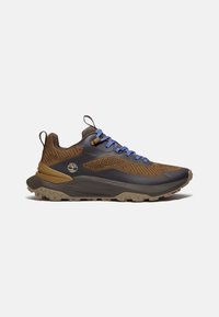 Brown and black athletic shoe with textured fabric, blue laces, and a rugged sole. Features a logo on the side and a cushioned heel.