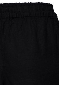 Ceinture élastique noire de pantalon en tissu léger avec couture froncée pour un ajustement réglable.