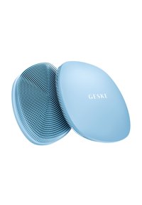 Brosse à cheveux bleue de forme arrondie avec des poils texturés, dotée d'un couvercle lisse avec le logo "GESKE" sur le dessus. Design compact et ergonomique.