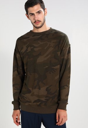 Brown camouflage sweatshirt with long sleeves, ribbed neckline, and cuffs. Made of soft fabric, featuring dark and light green patterns.