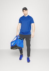 Nike Performance TEE RESET - Sport T-Shirt - game royal/black