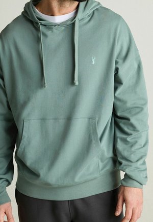 Felpa verde menta con tasca a canguro, cappuccio con cordoncino e logo accento. Realizzata in un morbido tessuto testurizzato, con una vestibilità comoda.