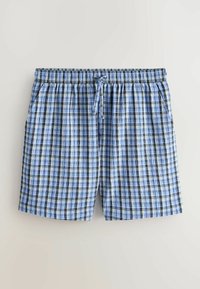 Caleçons pour hommes à carreaux bleu clair et noir avec taille élastique et fermeture à lacet devant sur fond uni.