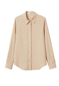 Chemise beige à manches longues avec col pointu et un motif géométrique subtil sur l'ensemble.