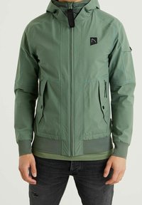 Green hooded jacket with a zip closure, featuring two front pockets, mesh accents at the hem, and contrasting stitching details.