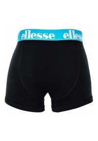 Mustat bokserit, joissa on leveä turkoosi vyötärö, jossa on valkoista "ellesse"-brandiusta. Sujuva kangas, jossa on ommeltuja yksityiskohtia reunoissa.