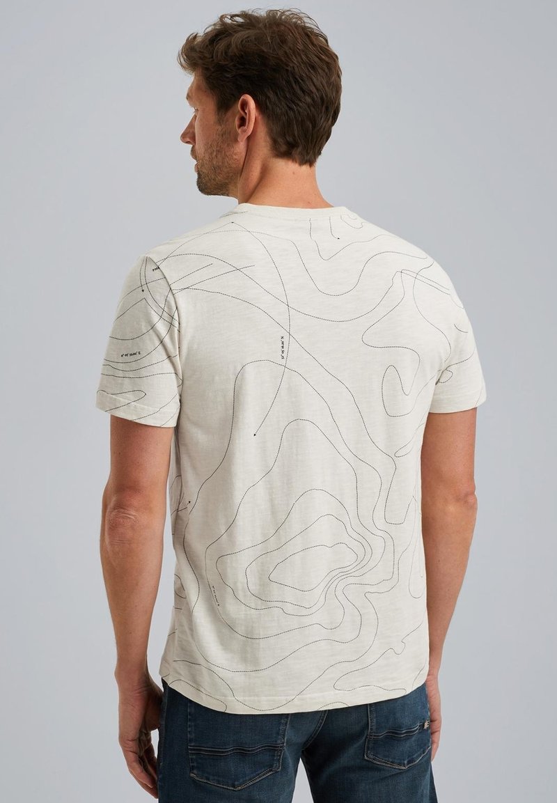 Licht beige t-shirt met zwart contourlijnen patroon, korte mouwen en een ronde hals. Heeft een zachte, gladde textuur.