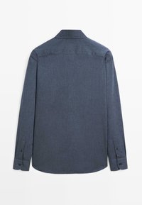 Dark blue long-sleeve shirt made of textured fabric, featuring a classic collar, buttoned cuffs, and a curved hemline.