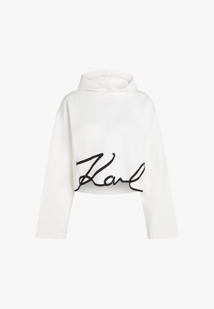 Valge lühikesed käised kapuutsiga särk pehmest materjalis, mille esipaneelil on must kiri. Sile tekstuur ja mugav lõige.