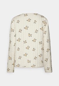 Giacca trapuntata color crema con stampa floreale. Presenta maniche lunghe, scollatura rotonda e design a pannelli cuciti. Tessuto testurizzato con piccoli dettagli.