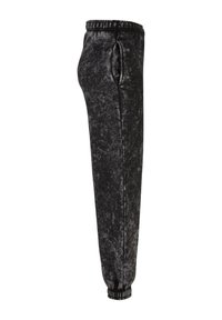 Sorte, fløyelsmyke joggebukser med elastisk midjebånd, sidelommer og smalende ben. Stoffet har et subtilt, teksturert mønster.