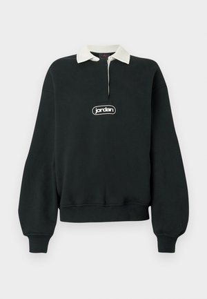 Schwarzer Pullover mit langen Ärmeln, weißem Kragen, Viertel-Reißverschluss vorne und einem zentralen Logoaufnäher. Weicher Stoff mit gerippten Bündchen und Saum.